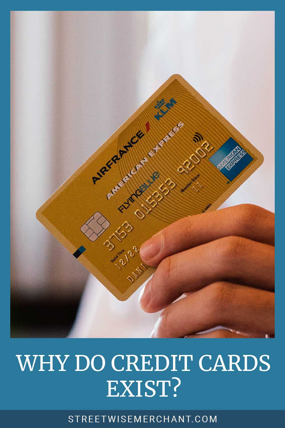 Man holding a card with his fingure - Why Do Credit Cards Exist?