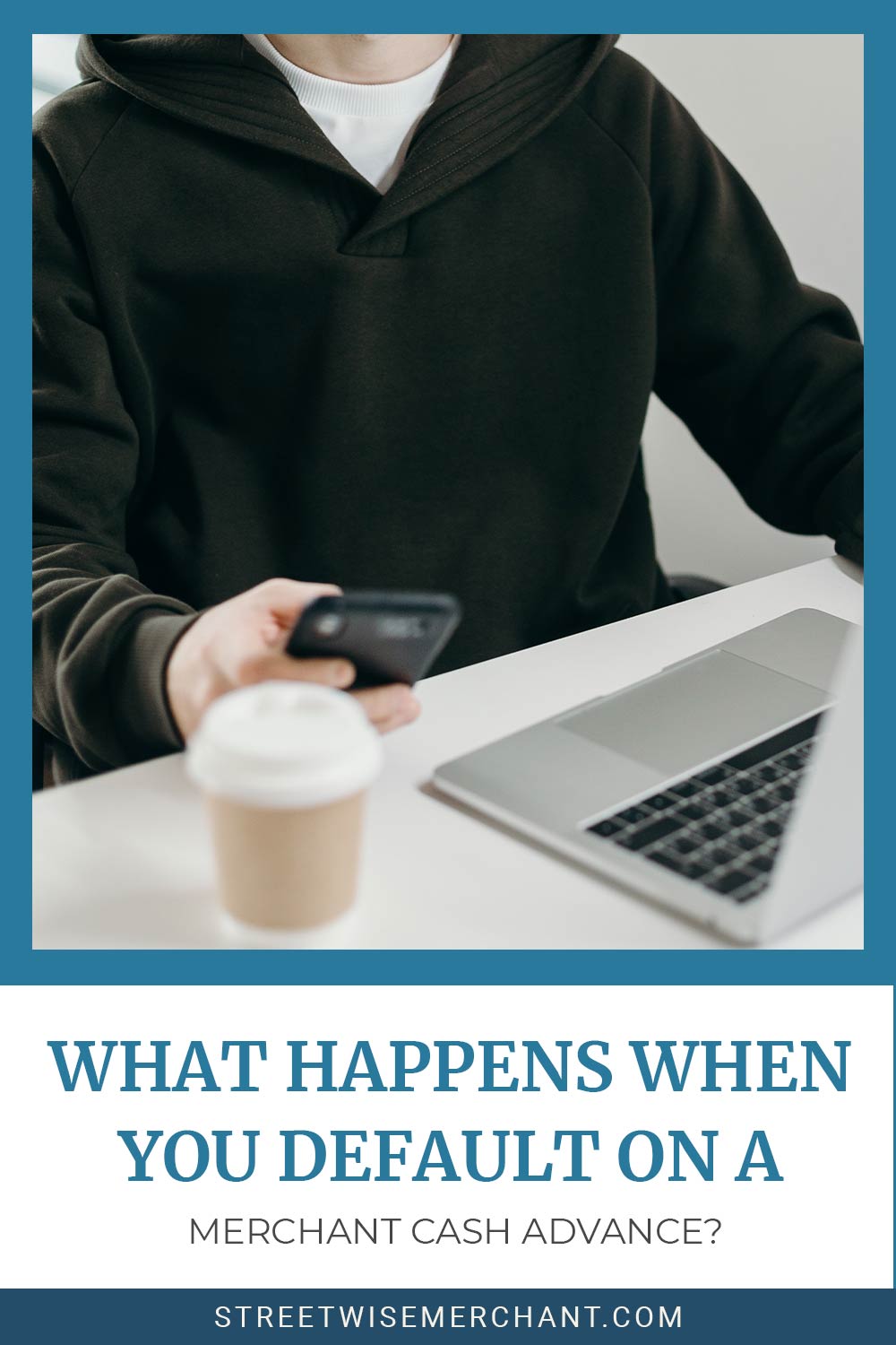 Personn wearing black hoodie workinh on laptop and holding a mobilephone - What Happens When You Default On a Merchant Cash Advance?
